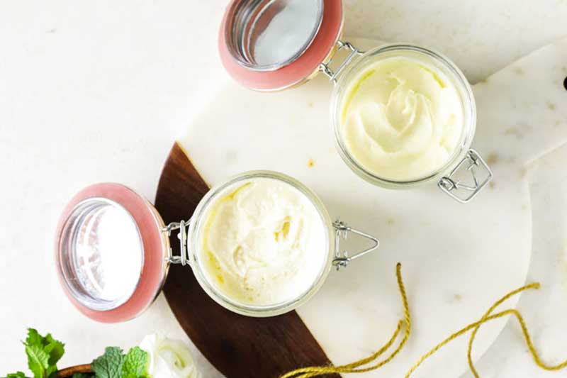 birds eye view of two glass jars filled with lotion