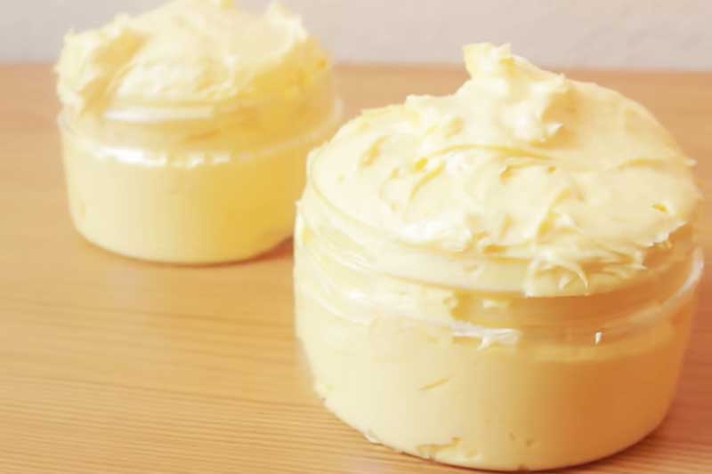 two jars filled with mango body butter