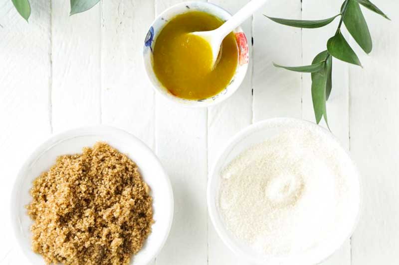 bowls of brown and white sugar and sugar mixed with oil