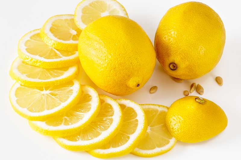 close up of lemons and lemon slices