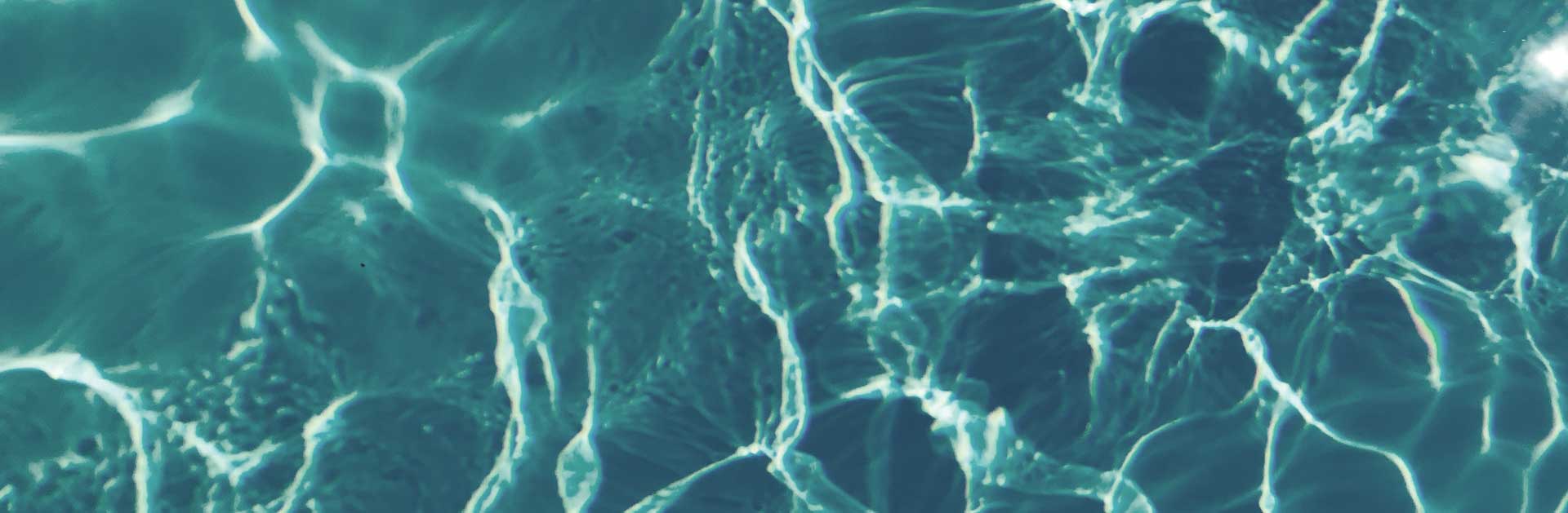 close up of the surface of shallow water reflecting light